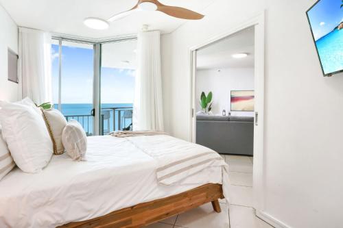 a bedroom with a bed and a view of the ocean at Ocean Views at Mantra Trilogy in Cairns