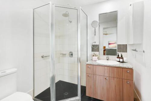 a bathroom with a shower and a sink at Ocean Views at Mantra Trilogy in Cairns