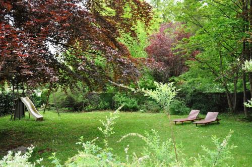 a park with two benches and a slide at B&B Le Bois Dormant in Spa