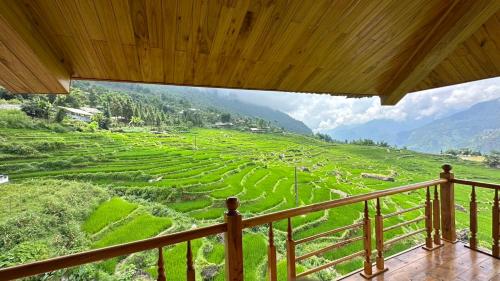 a balcony with a view of a green field at Hmong Eco Villas in Sa Pa