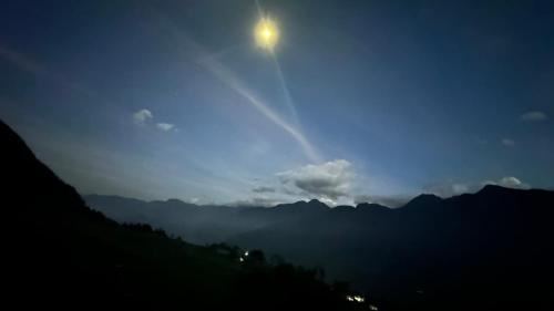 a view of the sun rising over the mountains at night at Hmong Eco Villas in Sa Pa