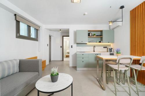 a living room and kitchen with a couch and a table at Olia Thassos - Luxury Apartments in Limenas