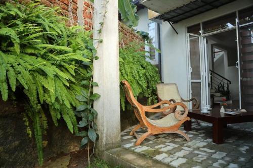 a chair and a table on a patio at The Paddy in Kottawa