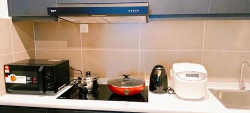 a kitchen counter with a toaster and a mixer on it at Kulai d putra suites beside ioiMall near JPO and Airport in Kulai