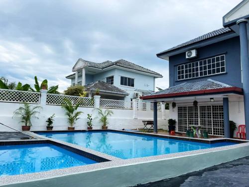 a swimming pool in front of a house at MY VILLA PD in Port Dickson