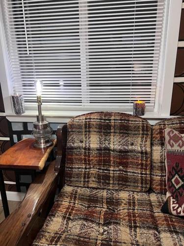 a living room with a couch and a table and a window at Scout in Salem