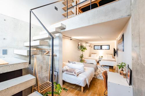 a loft apartment with a staircase and a living room at RiriLeo Koenji in Tokyo