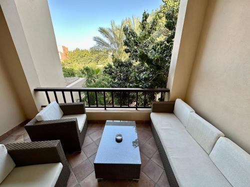 a balcony with couches and a coffee table and a view at 2 Bedroom Condo, with Pool, and Beach & Lagoon Access in Hurghada