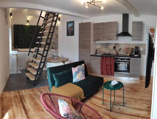 uma sala de estar com um sofá e uma cozinha em La Cabana Agréable logement avec Jacuzzi/Balnéo em Saint-Jean-dʼAngély