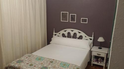 a bedroom with a white bed with a white headboard at Pensión Saint Mateo in Logroño