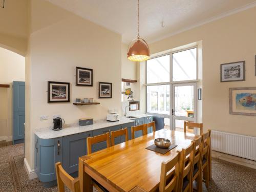 a kitchen and dining room with a wooden table at Roa Island House in Rampside