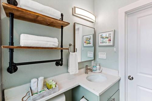 a bathroom with a sink and a mirror at The Anchor Beach House in Galveston