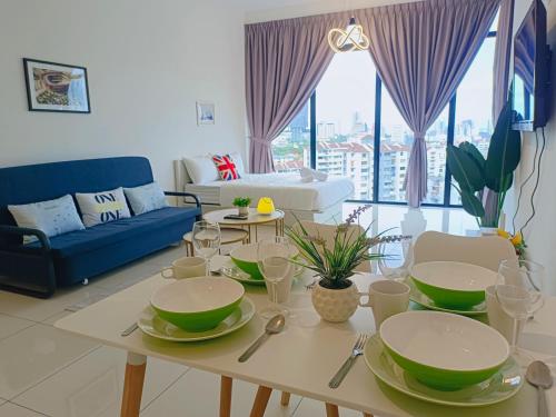 a living room with a table with green bowls on it at Rooftop Pool, 8 Pax, 2 Bedrooms, 2 Bathrooms, 2 Car Parks by Star Home in Jelutong