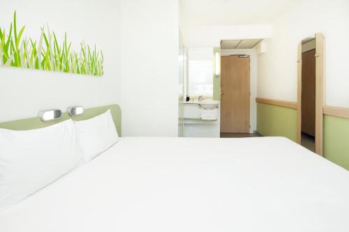 a bedroom with a bed and a mirror at Ibis Budget Madrid Centro Las Ventas in Madrid