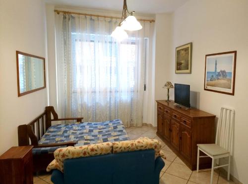 a bedroom with a bed and a desk and a television at Grottammare mon amour Pineta in Grottammare
