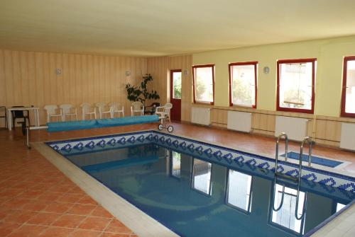 a large swimming pool in a room with at Hotel Palota City in Budapest