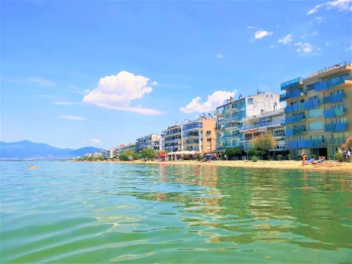 a view of a beach with buildings and the water at Niko's Apartment - Beautiful Sea Apartment ! in Perea