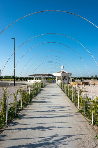 an arch over a walkway on the beach at HDB Al Khobar Resort & Spa in Al Khobar