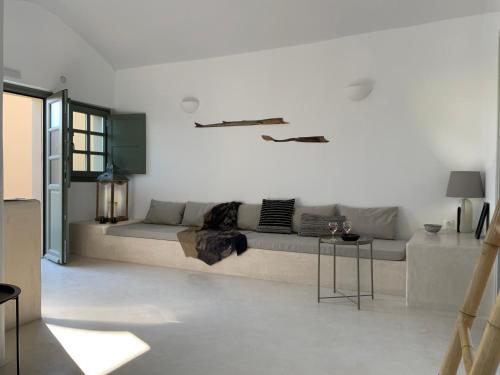 a living room with a couch and a table at Ambelia Traditional Villas in Oia