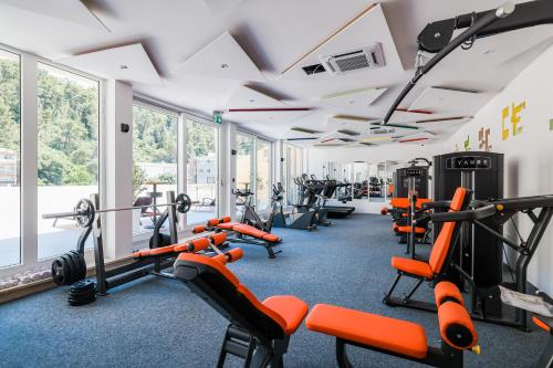 a gym with a row of treadmills and machines at Hotel Kanjon Zrmanje in Obrovac