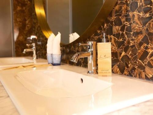 a white sink in a bathroom with a mirror at Villa C62 - Private Swimming Pool 100M2 - In Stunning Sea Front Location in Mui Ne