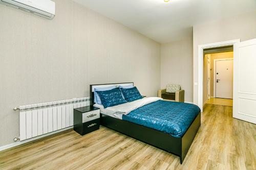 a bedroom with a bed with blue pillows on it at Sabah walk Spa and fitness in Baku