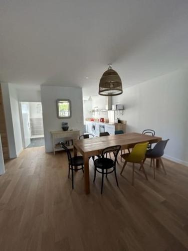 une salle à manger avec une table et des chaises en bois dans l'établissement Superbe appartement bord de mer, à Saint-Mandrier-sur-Mer