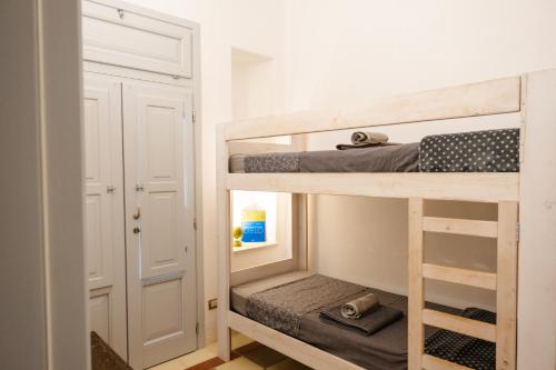 a bedroom with two bunk beds and a closet at I Giardini di Pomona in Cisternino