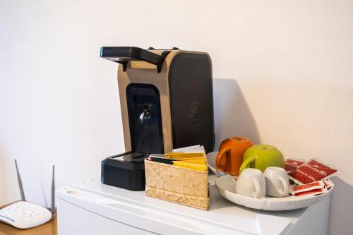 a coffee maker sitting on top of a white shelf at I Giardini di Pomona in Cisternino