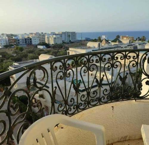 a white chair sitting on top of a balcony at App sea view kantaoui in Sousse