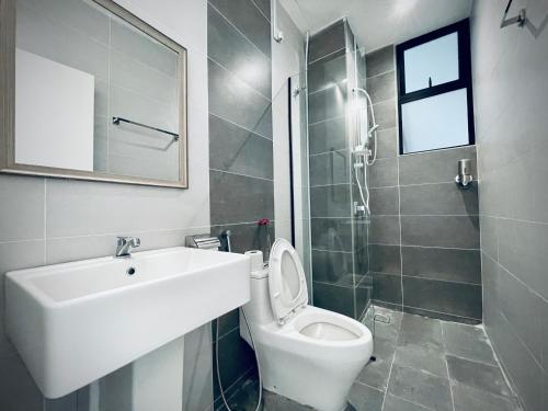 a bathroom with a sink and a toilet and a shower at The Cove Hillside@Loft in Ipoh