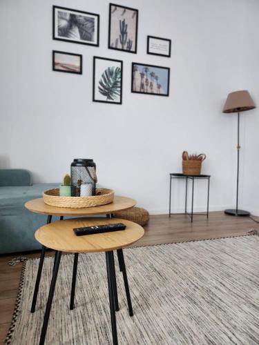 a living room with a table with a remote control on it at ADM Cozy Home - Entire private house&garden, close to Therme and Edenland in Tunari