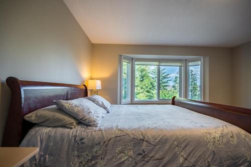 a bedroom with a large bed with a window at First Estate Winery in Peachland