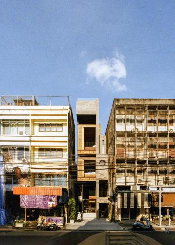 two tall buildings next to a street with at Na Tanao 1969 in Bangkok