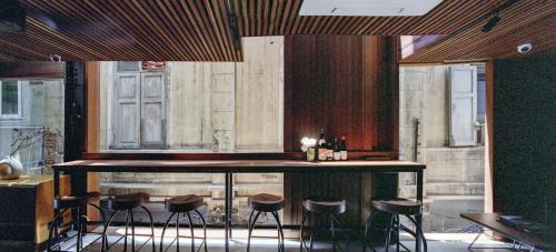 a bar in a restaurant with stools around it at Na Tanao 1969 in Bangkok