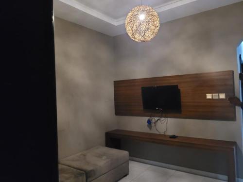 a room with a flat screen tv and a couch at Salalah Beach Villas in Salalah
