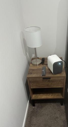 a table with a lamp and a radio on it at Trafalgar Place in Auckland