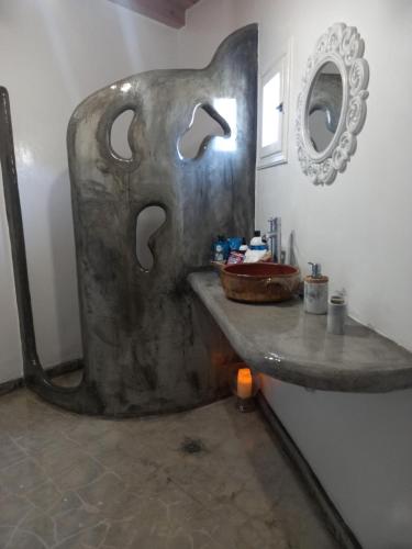 a bathroom with a sink and a mirror at Νύμφη in Kimolos
