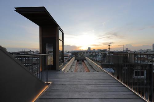 a view of a balcony of a building with the sunset at Na Tanao 1969 in Bangkok