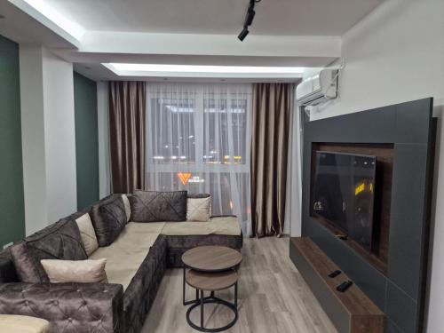 a living room with a couch and a television at MB Apartments in Jagodina