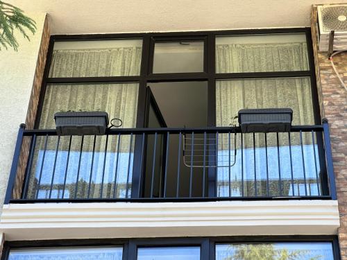 a balcony with two lights and a window at French Hotel in K'obulet'i
