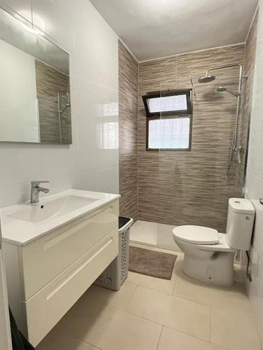 a bathroom with a sink and a toilet and a shower at Carabeillo Seaview Apartment in Nerja