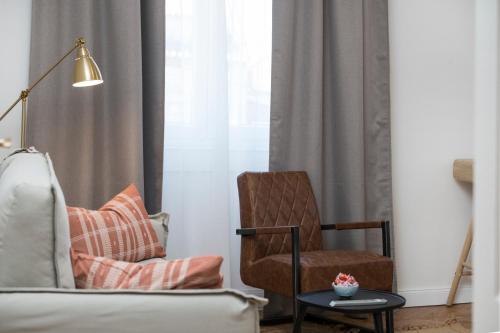 a living room with a chair and a lamp at Luxury Apartments Bella - Split Centre w Free Parking in Split