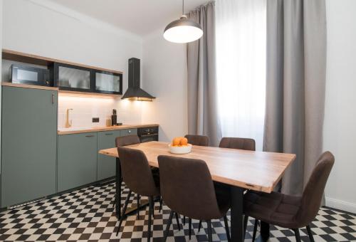 a kitchen and dining room with a wooden table and chairs at Luxury Apartments Bella - Split Centre w Free Parking in Split