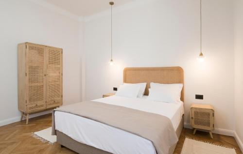 a bedroom with a large white bed with two pillows at Luxury Apartments Bella - Split Centre w Free Parking in Split