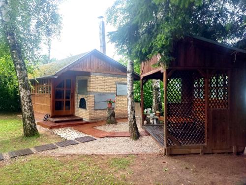 a small house with a porch and a barn at Vila Gardenia in Sarajevo