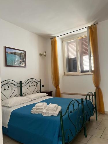 Un dormitorio con una cama azul con toallas. en Corte San Martino, en Mesagne