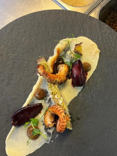 a plate of food with shrimp and vegetables on it at Hotel Sportalmmm, Hoch-Genuss in Zauchensee