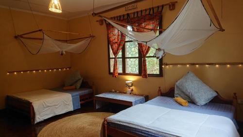 a bedroom with two beds and a window at Kiwavi Home in Moshi