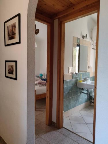 a bathroom with a sink and a mirror at Bouganville in Costa Rei